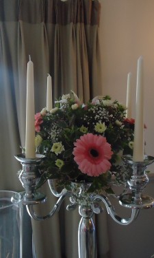 Candelabra arrangement with pink gerbera, spray chrysanthemums and gypsophila