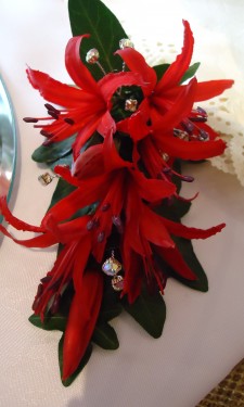 Red nerine corsage with iridescent crystal