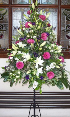 Porch arrangement with pink gerbera, ivory lilies, alstromeria, and purple lizianthus