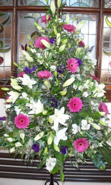 Porch arrangement with pink gerbera, ivory lilies, alstromeria, and purple lizianthus