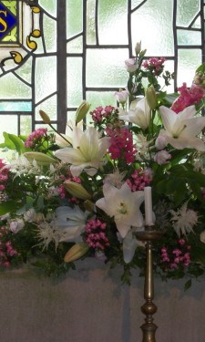 Altar arrangement of ivory lily, astilbe, pink bouvardia, antirrhinum, and Solomon's seal
