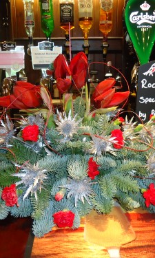 Christmas arrangement of amaryllis, erygium, spray carnations and red ting at The Harp Inn Letterston