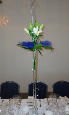 Asiatic lily, monstera leaf and sisal in lily vase with lights