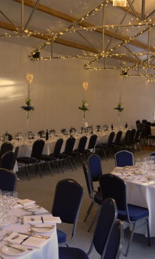 Oriental lilies, monstera leaves and sisal in medium lily vases with lights and mirror tiles at Crug Glas