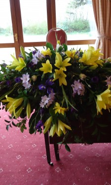 Registrar's table/ top table arrangement of yellow lilies and tulips and purple and lilac freesia