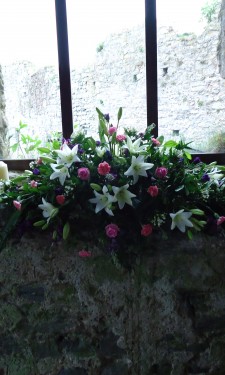 White lilies, bouvardia, pink roses, and purple lizianthus and stocks at Manorbier Castle