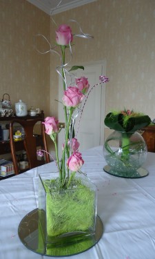 Contemporary look of roses in a tank vase with wire spirals