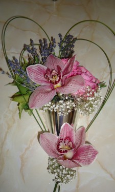 Contemporary style pew end with orchids, roses, flexi grass, gypsophila and lavendar