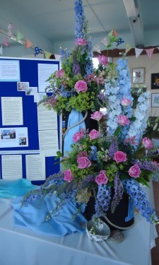 Pink roses, blue delphiniums, antirrhinums,buddleia and alchemilla mollis.