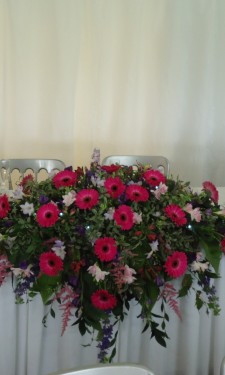 Top table arrangement with gerbera freesia, astilbe, lizianthus & foliage