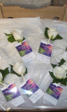 Ivory rose buttonholes and corsages
