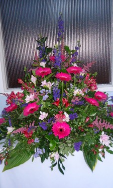 Chapel porch arrangement with pink gerbera, alstromeria and astilbe & purple statice and larkspur