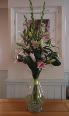 Pink lily and gladiolus in hotel reception