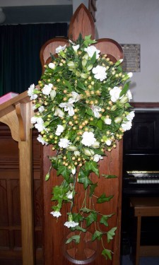 Pew end with white alstromeria, spray carnations and peach hypericum berries