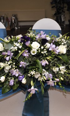 Top table arrangement containing ivory freesia, lizianthus, bouvardia & roses and purple/ lilac freesia and lizianthus