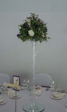 Table arrangement on a lily vase with roses, lizianthus, & freesia & lights